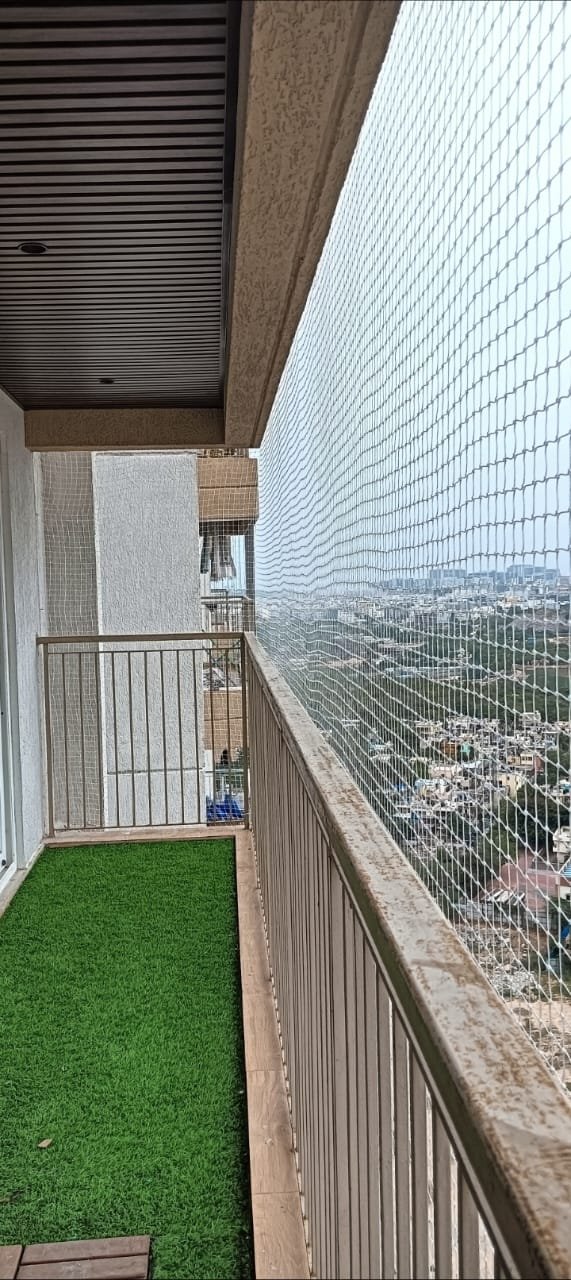 Balcony safety net installation with a city view