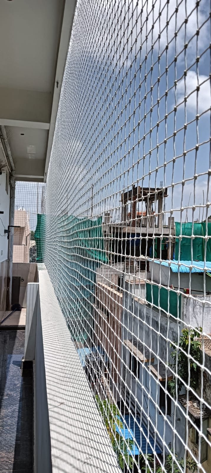 Side balcony safety net installation in daylight